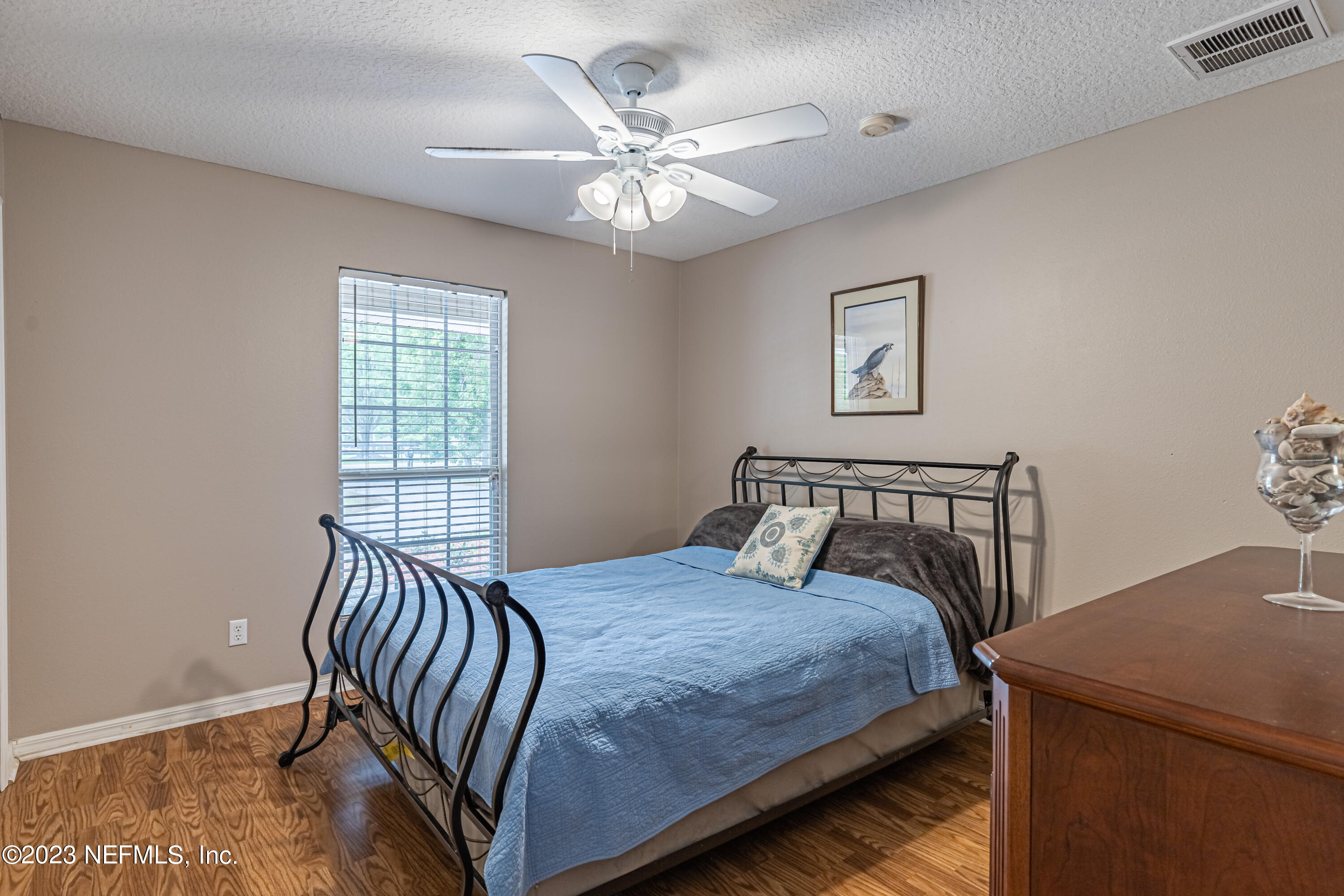 1193 Marlee Road St. Johns, FL 32259 - Photo 25 of 63 a bedroom with a large bed and a chandelier