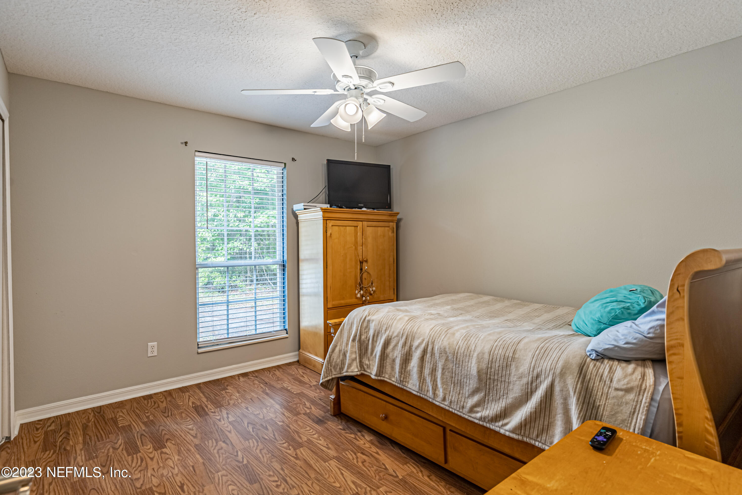 1193 Marlee Road St. Johns, FL 32259 - Photo 30 of 63 a bedroom with a bed and a chandelier