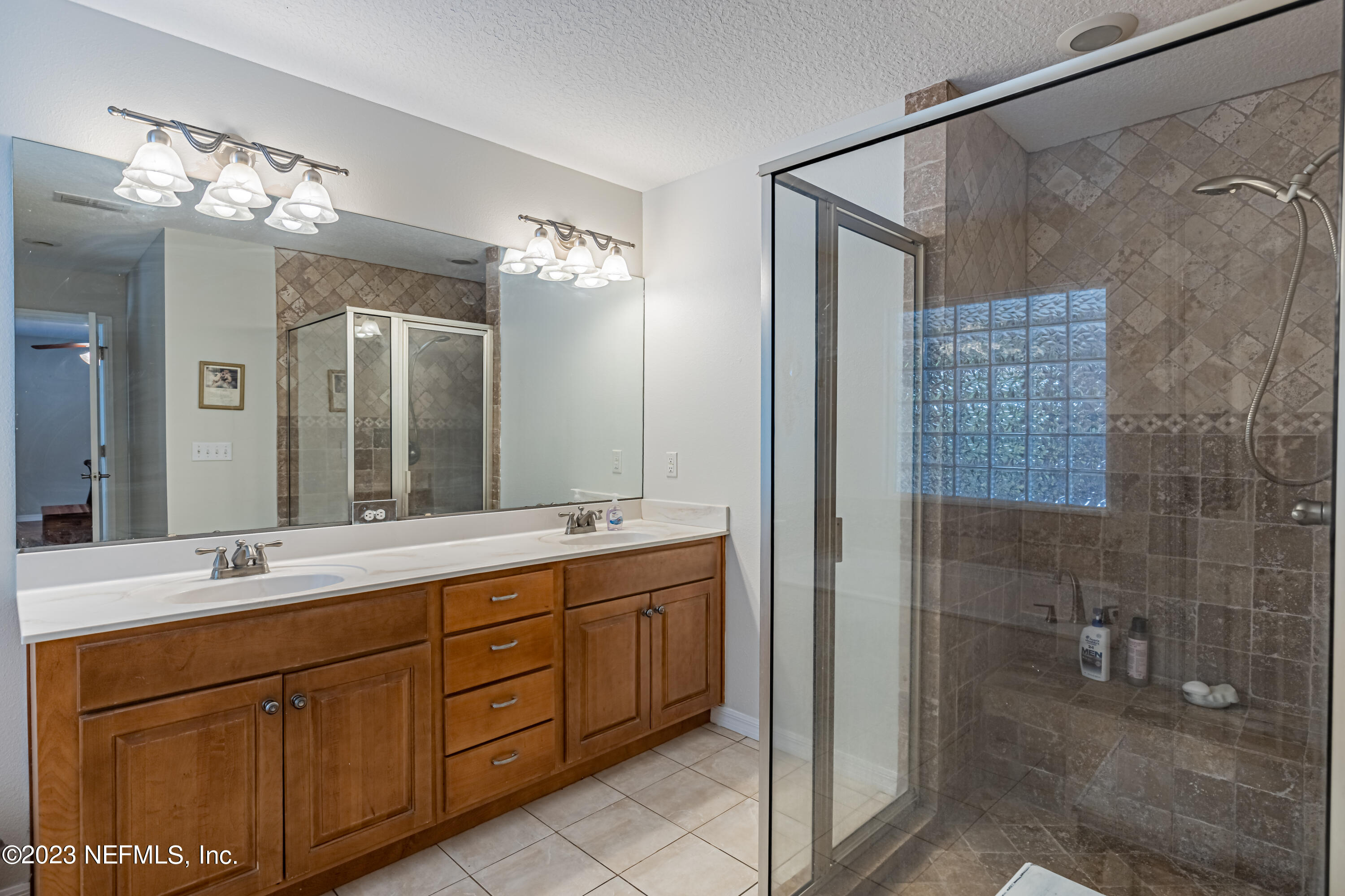 1193 Marlee Road St. Johns, FL 32259 - Photo 34 of 63 a bathroom with a double vanity sink mirror and shower