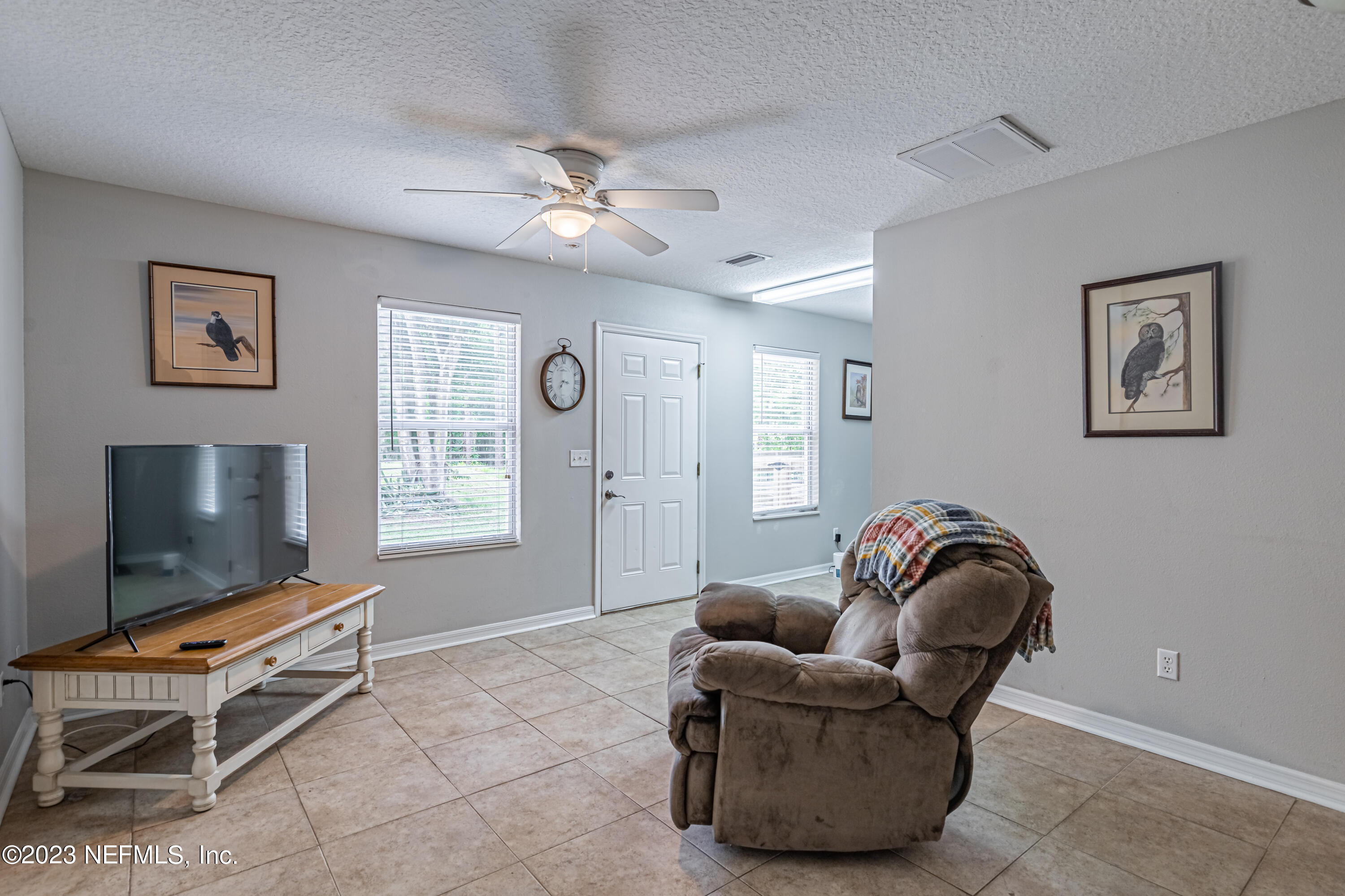 1193 Marlee Road St. Johns, FL 32259 - Photo 37 of 63 a living room with furniture a flat screen tv and a window