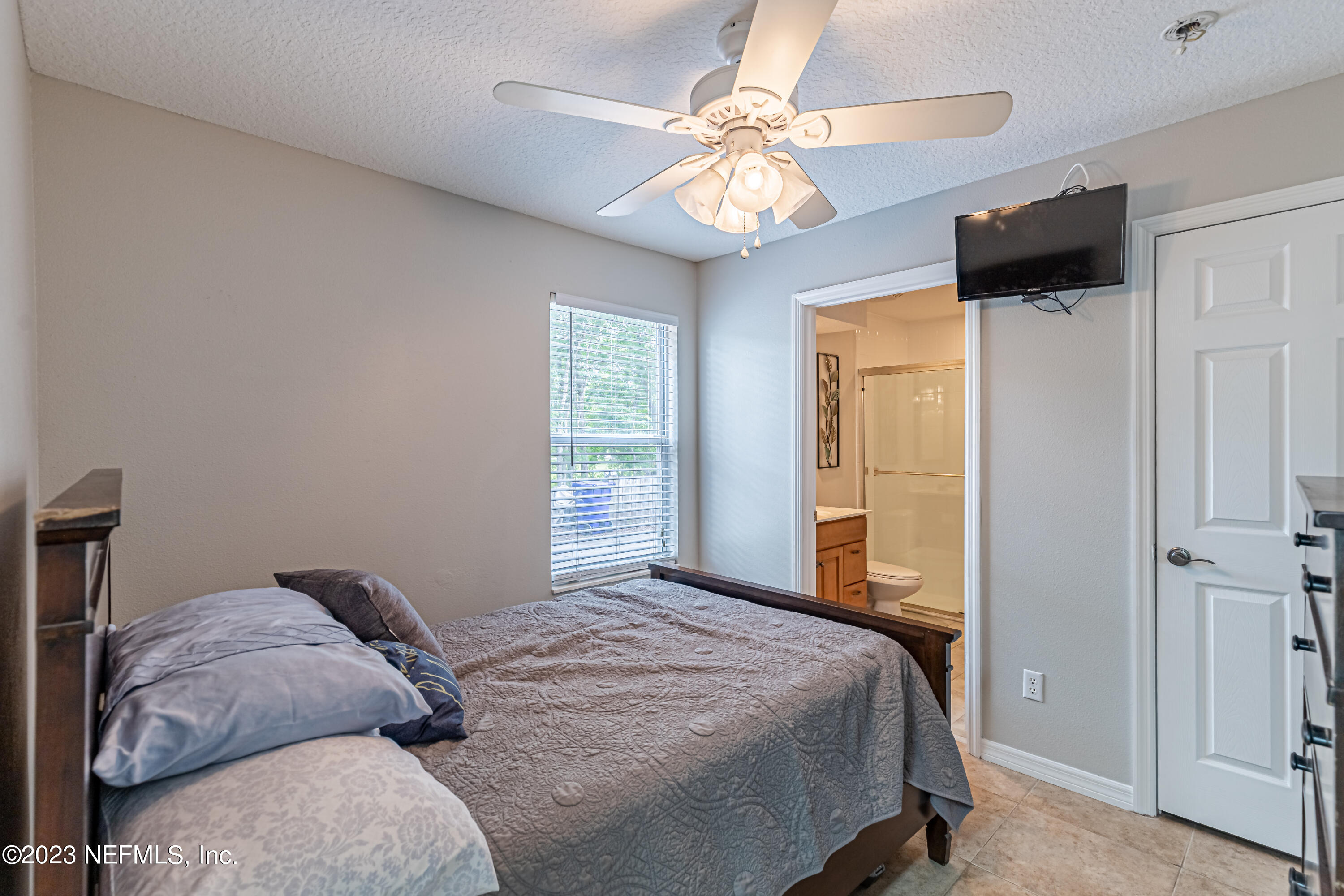1193 Marlee Road St. Johns, FL 32259 - Photo 40 of 63 a bedroom with a bed and a chandelier