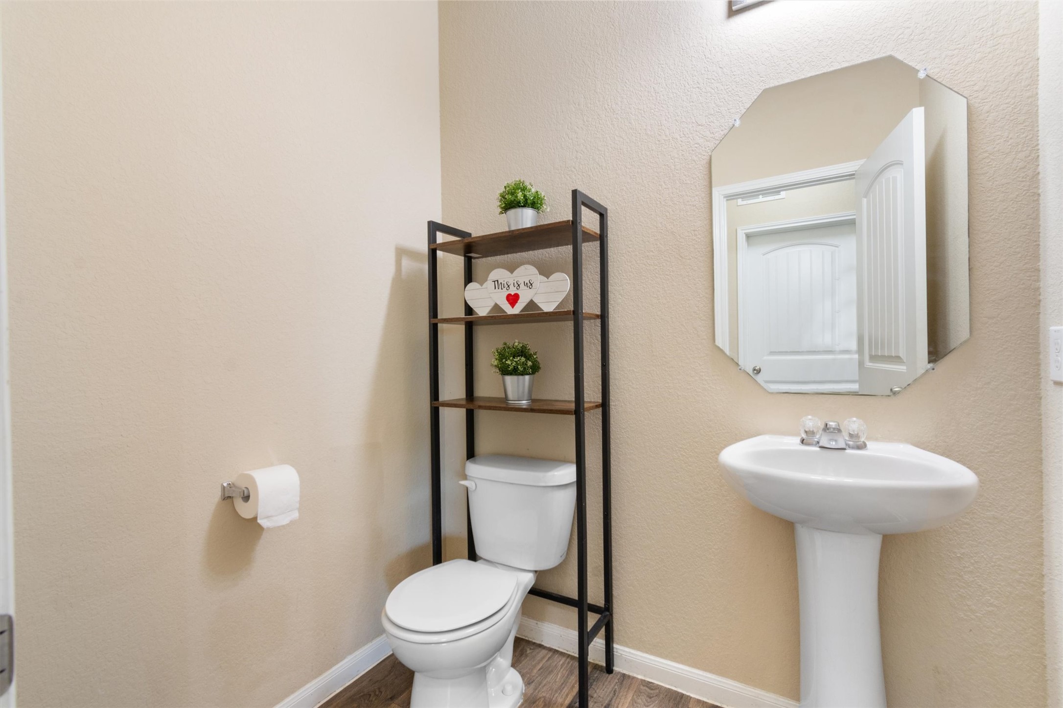 11620 Carbrook Road Manor, TX 78653 - Photo 13 of 40 a bathroom with a toilet sink and mirror