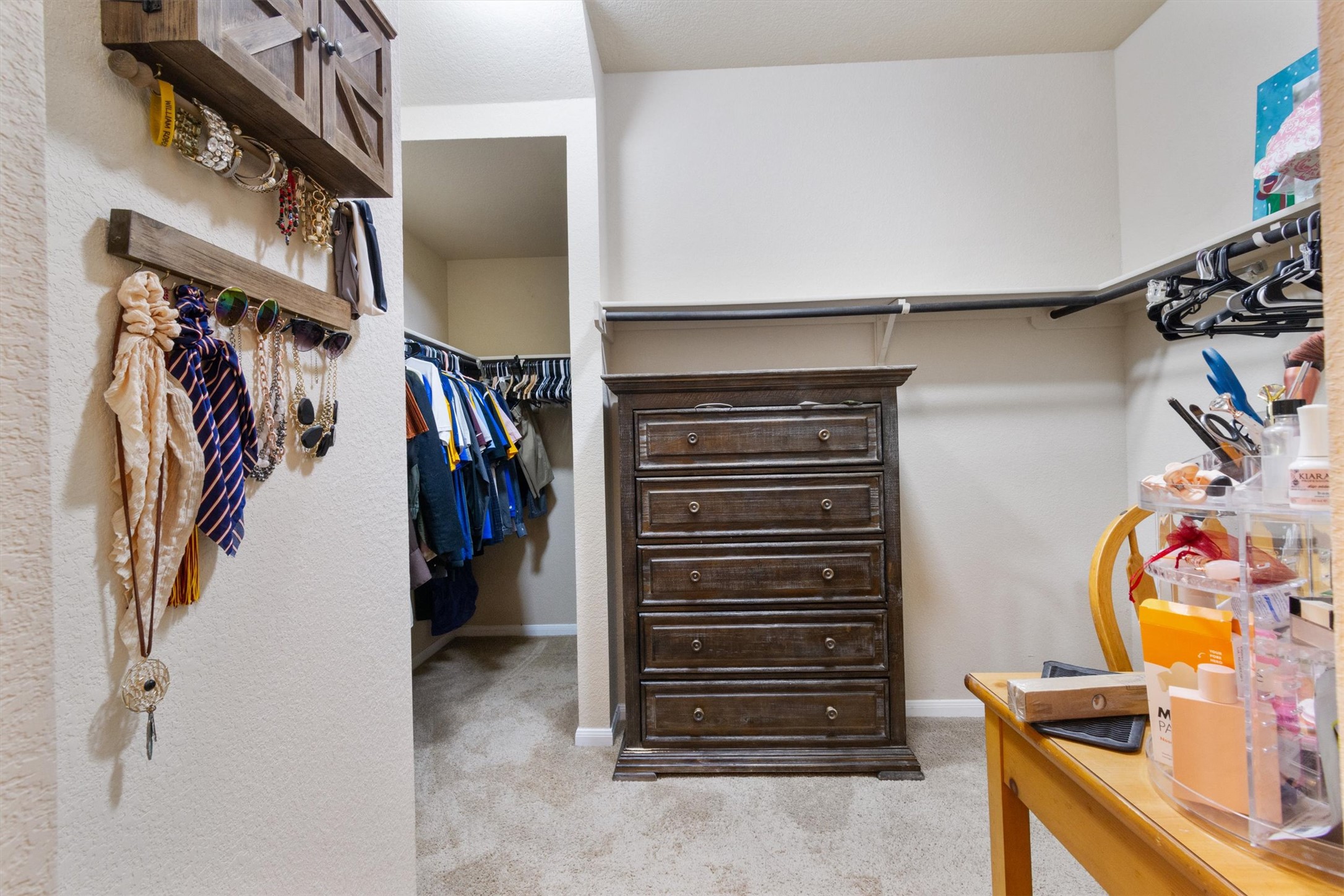 11620 Carbrook Road Manor, TX 78653 - Photo 15 of 40 a view of walk in closet with clothes and shoes
