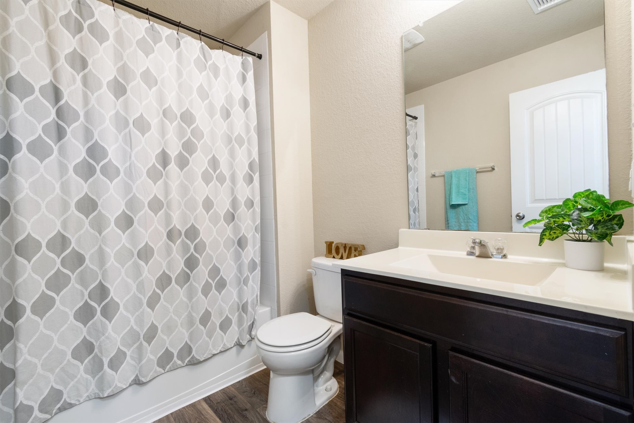 11620 Carbrook Road Manor, TX 78653 - Photo 24 of 40 a bathroom with a sink a toilet and shower curtain