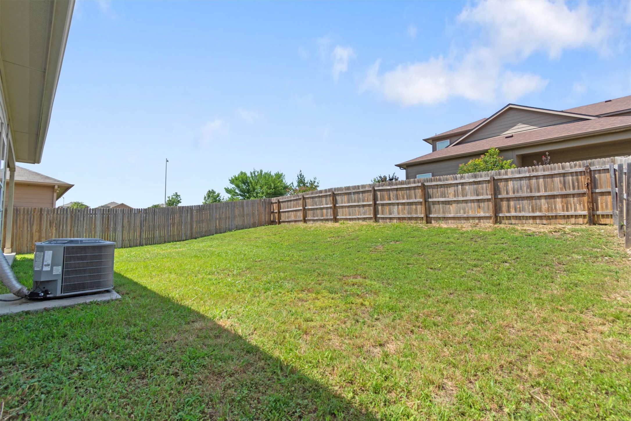 11620 Carbrook Road Manor, TX 78653 - Photo 32 of 40 a view of a house with a big yard and a fountain