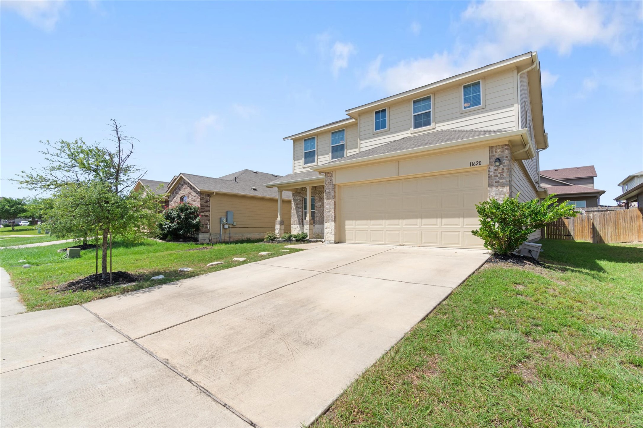 11620 Carbrook Road Manor, TX 78653 - Photo 40 of 40 a front view of a house with a yard and garage