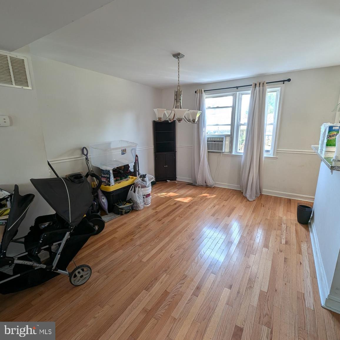 4219 Colborne Road Baltimore, MD 21229 - Photo 6 of 22 a room with wooden floor and glass door