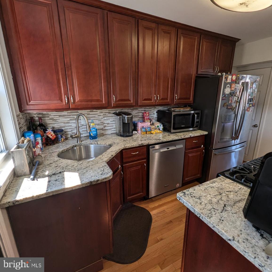 4219 Colborne Road Baltimore, MD 21229 - Photo 9 of 22 a kitchen with a sink a stove and cabinets