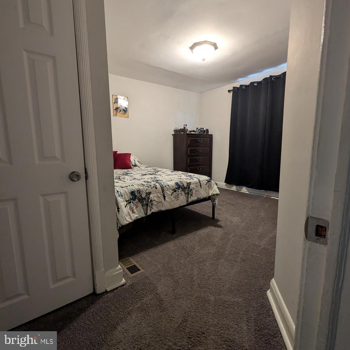 4219 Colborne Road Baltimore, MD 21229 - Photo 10 of 22 a bedroom with a bed and a mirror