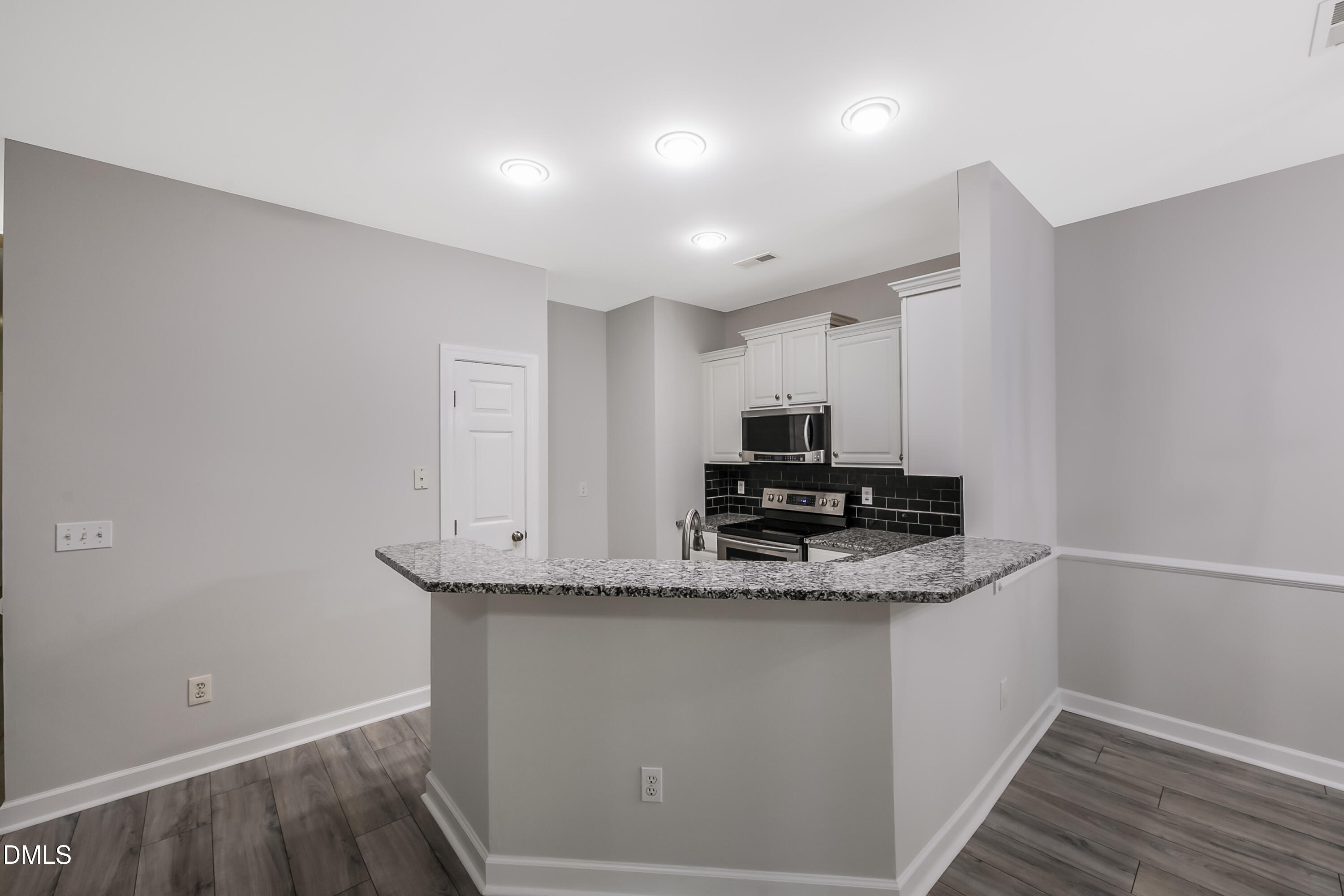 2639 Broad Oaks Place Raleigh, NC 27603 - Photo 11 of 24 a kitchen with kitchen island granite countertop a sink and a stove top oven