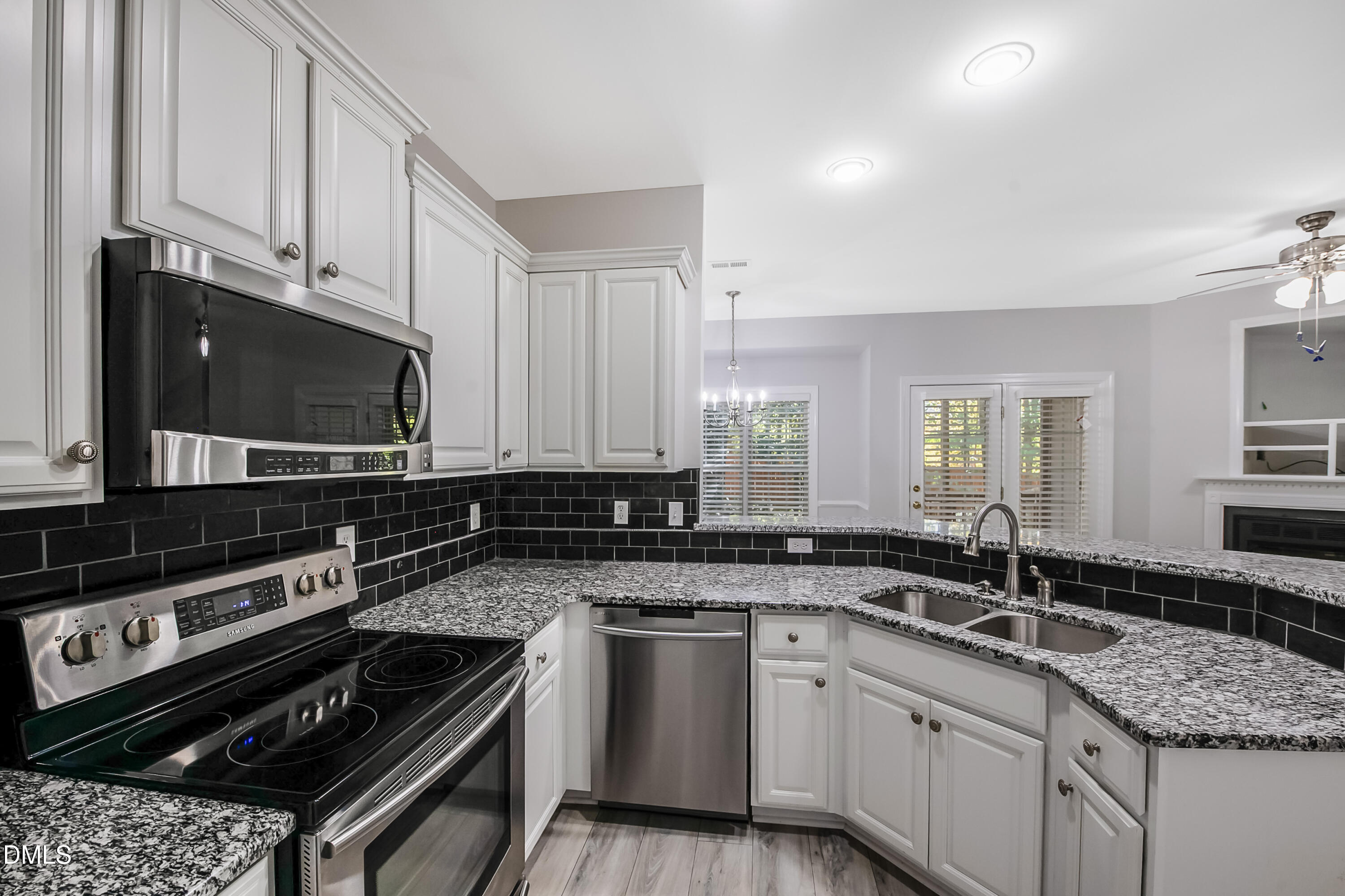 2639 Broad Oaks Place Raleigh, NC 27603 - Photo 12 of 24 a kitchen with stainless steel appliances a sink dishwasher stove microwave and cabinets