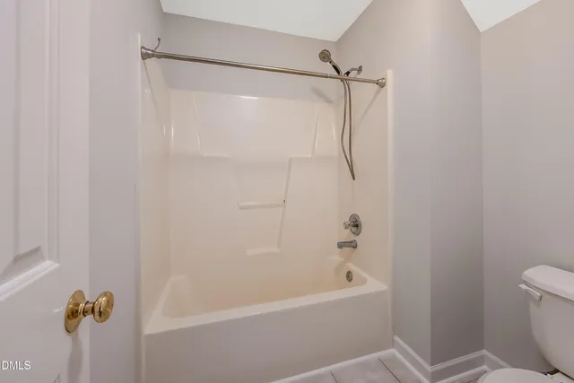 a bathroom with a shower and a toilet