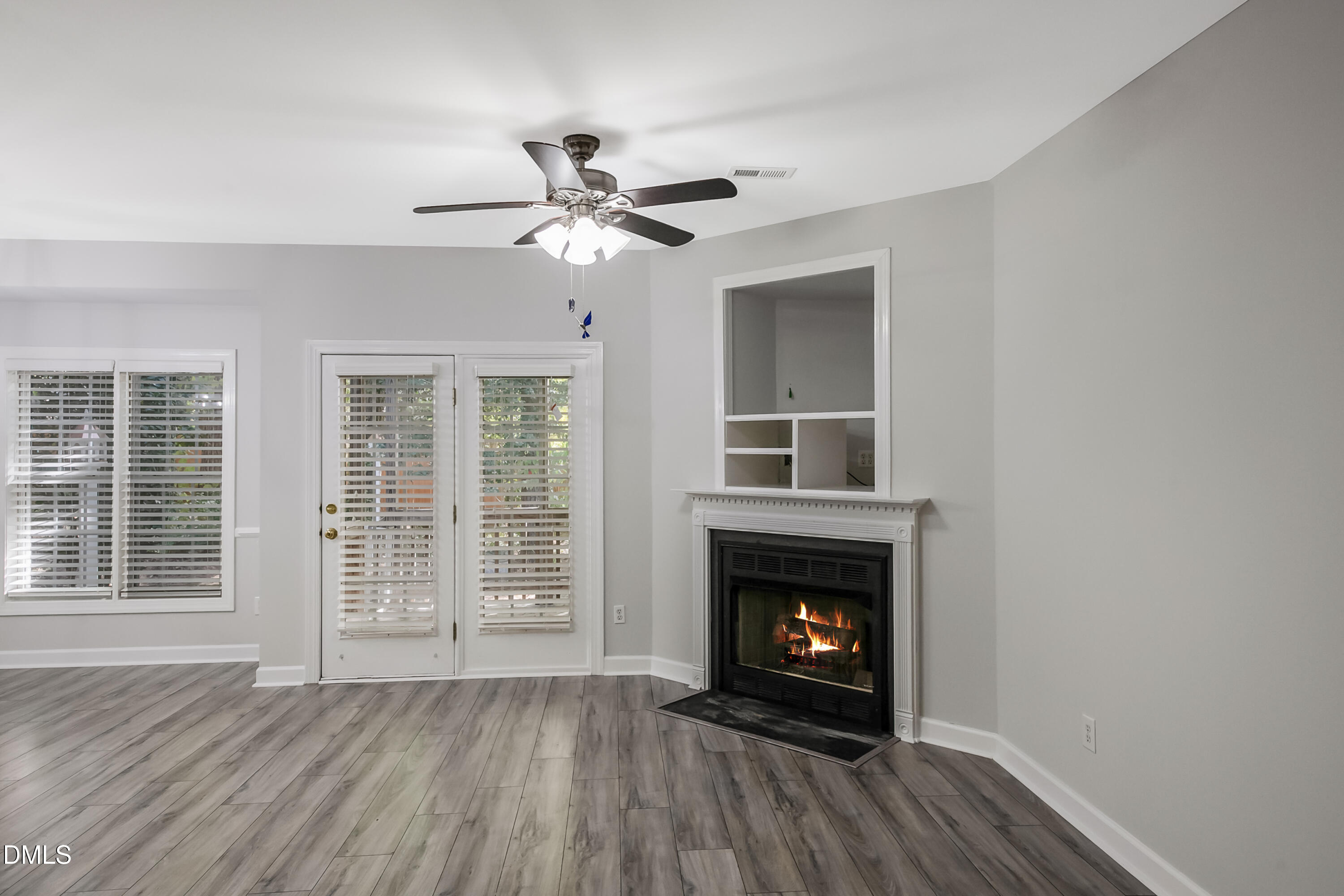 2639 Broad Oaks Place Raleigh, NC 27603 - Photo 9 of 24 a view of an empty room with wooden floor fireplace and a window