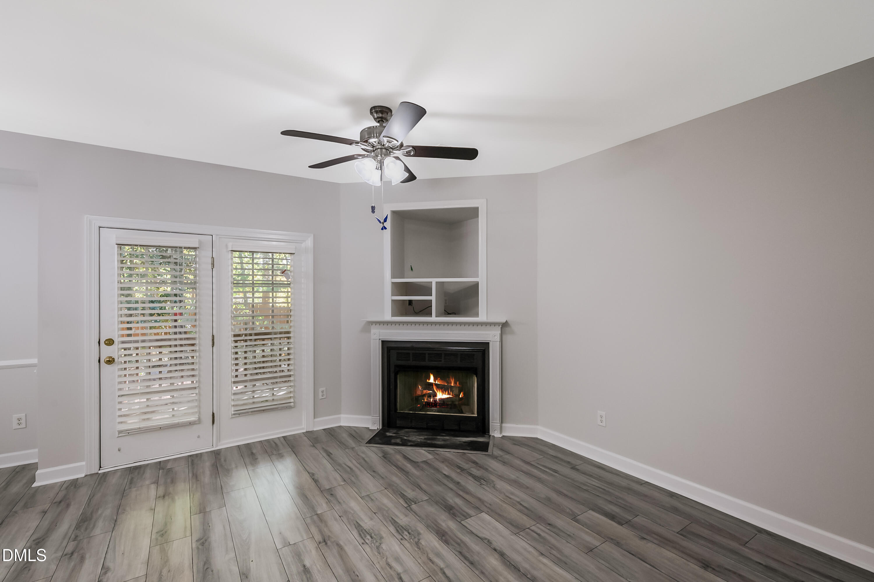 2639 Broad Oaks Place Raleigh, NC 27603 - Photo 10 of 24 a view of an empty room with wooden floor fireplace and a window