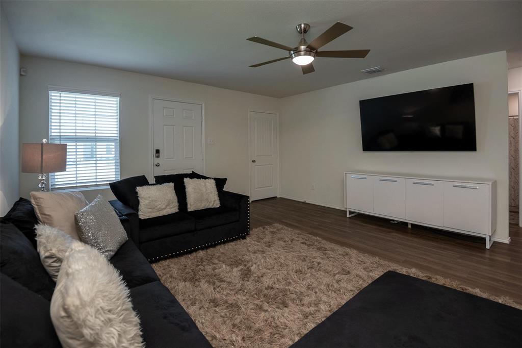 1215 Fairford Road Crandall, TX 75114 - Photo 2 of 17 a living room with furniture and a flat screen tv