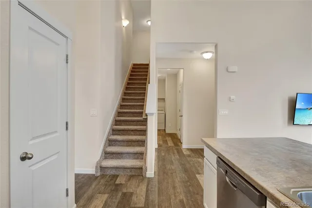 a view of a hallway with wooden floor and entryway