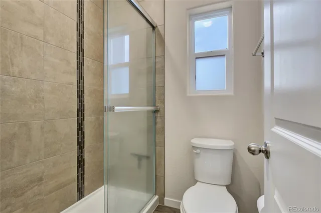 a bathroom with a toilet and shower