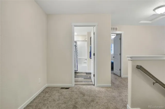an empty room with closet and mirror