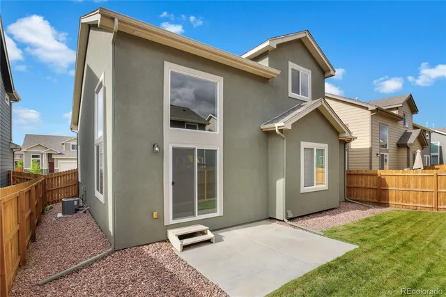 a view of a backyard with wooden fence