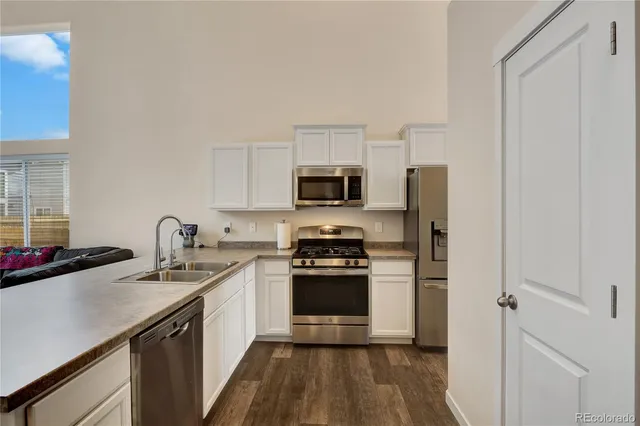 a kitchen with a sink stove and refrigerator