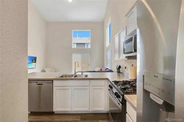 a kitchen with a sink stove and cabinets