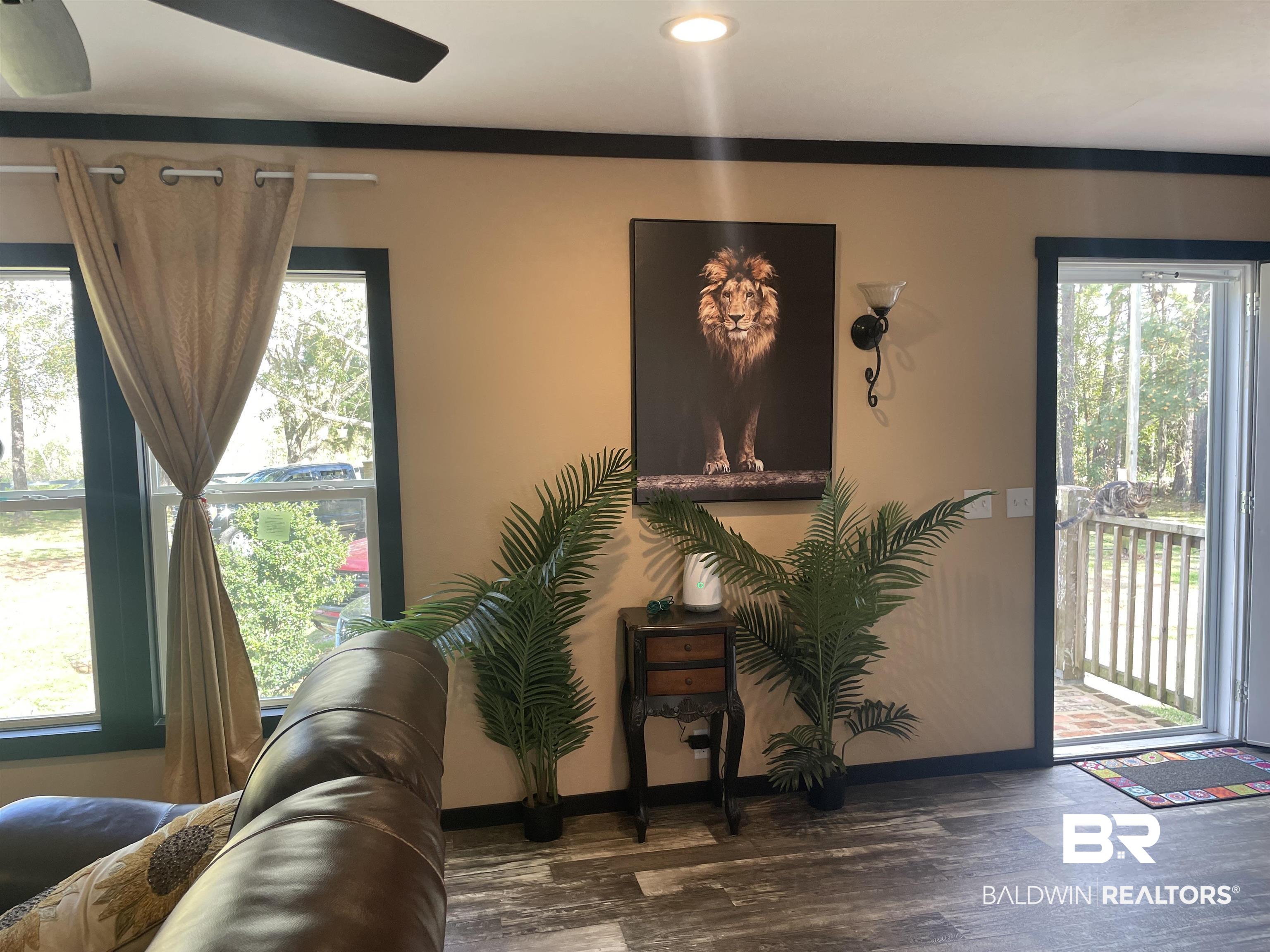 21593 Hubbard Road Robertsdale, AL 36567 - Photo 13 of 22 Living area with wood finished floors, baseboards, and a wealth of natural light