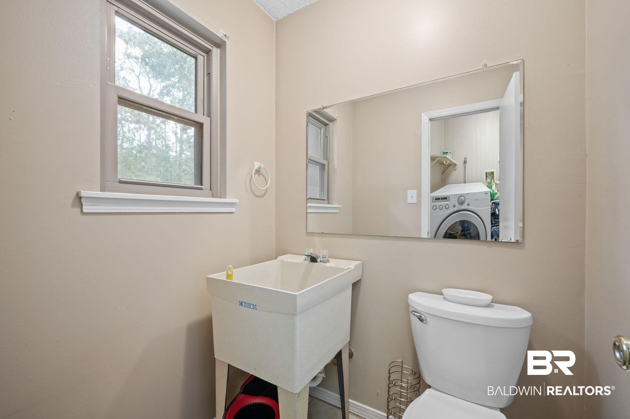 4566 McCrary Road, Unit A Semmes, AL 36575 - Photo 15 of 28 Bathroom with washer / dryer, sink, and toilet