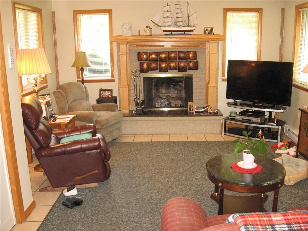 548 Ridgeview Road Mount Pleasant, PA 15666 - Photo 7 of 23 Den with propane fireplace. Lot of natural lighting.