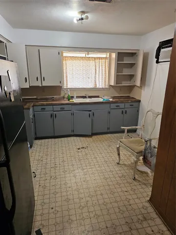 a kitchen with stainless steel appliances a refrigerator and a sink