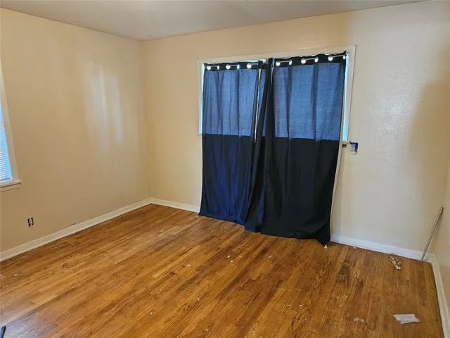 a view of a utility room with wooden floor