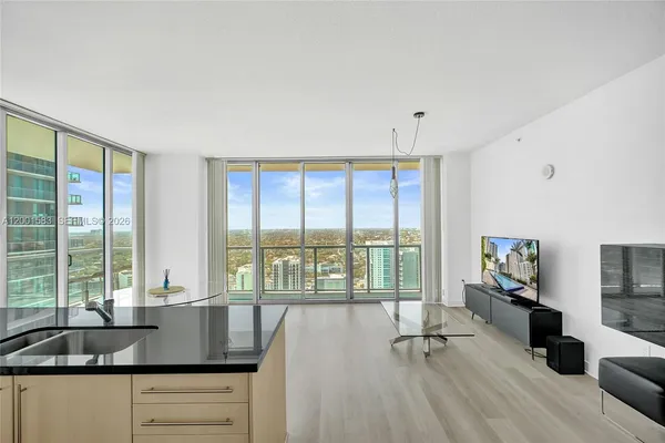 a kitchen with a sink and large window