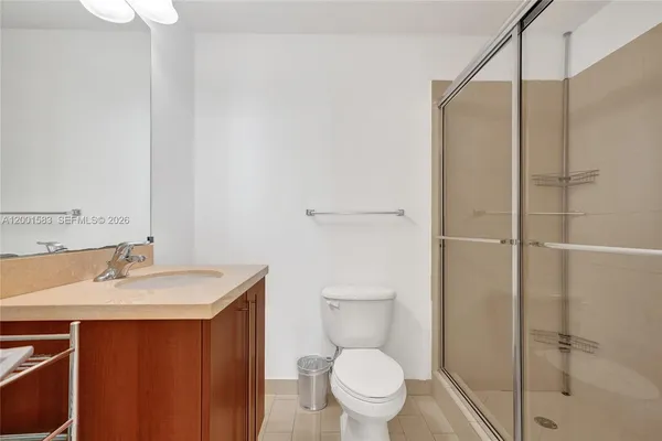 a bathroom that has a glass shower door