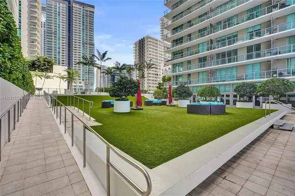 a view of a swimming pool with a garden and plants