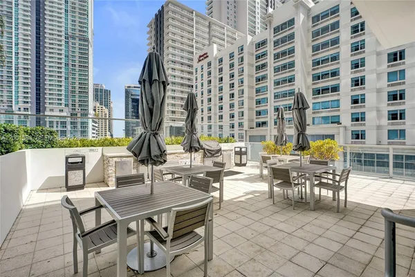 a view of an outside dining space with furniture
