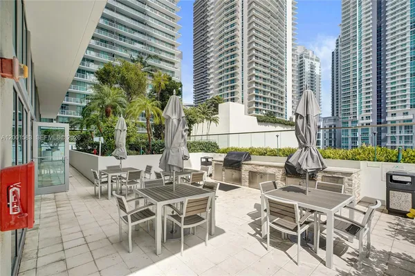 a view of a patio with chairs and table in the patio