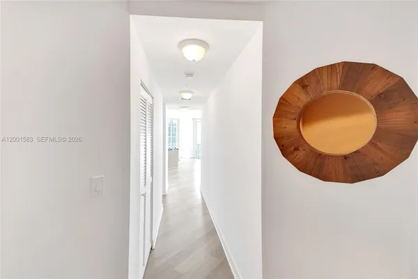 a view of a living room with hardwood floor and furniture