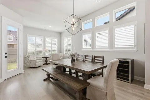 a dining room with furniture and wooden floor