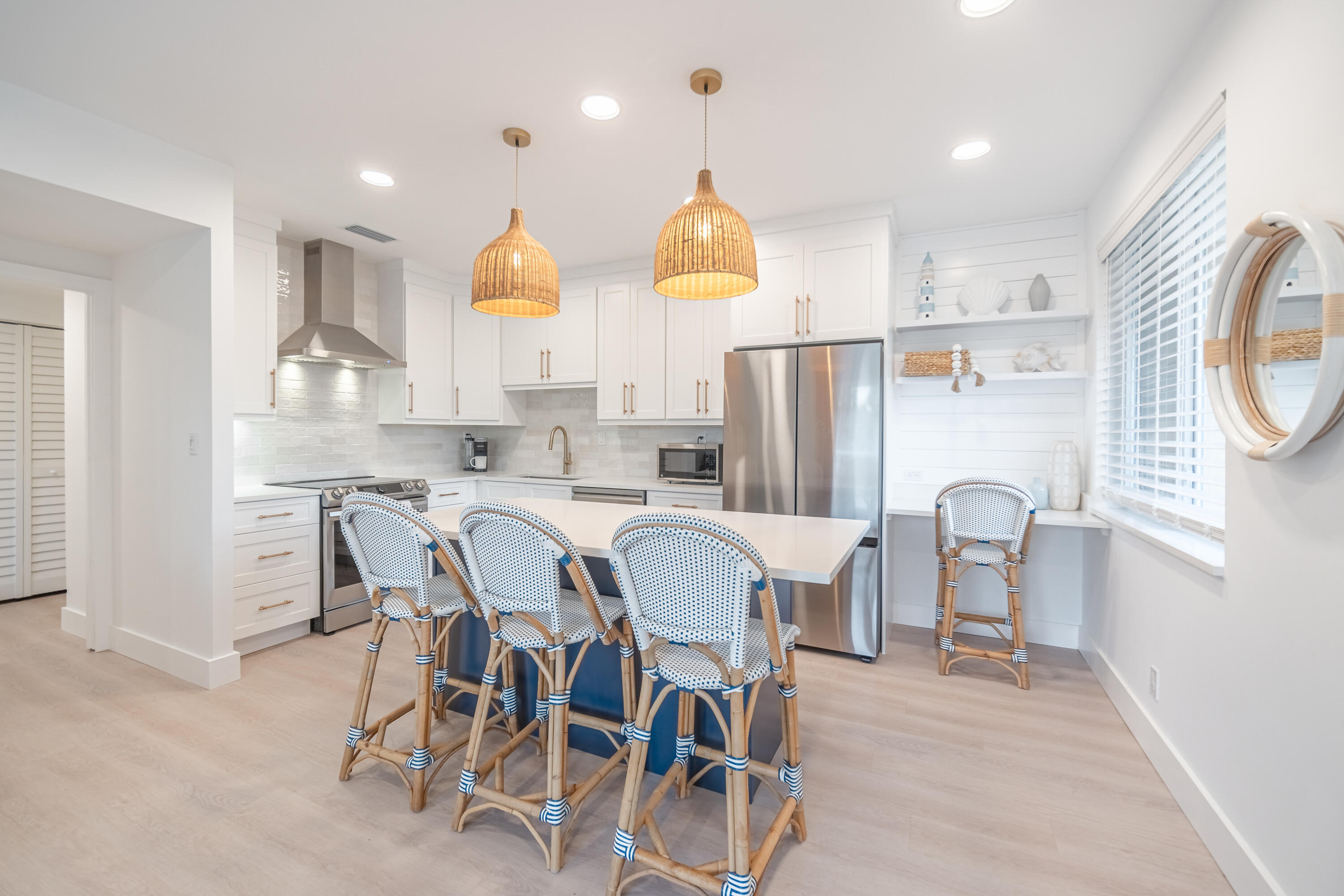 a dining room filled chandelier and kitchen view