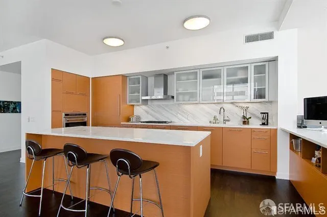 a kitchen with stainless steel appliances granite countertop a sink and cabinets