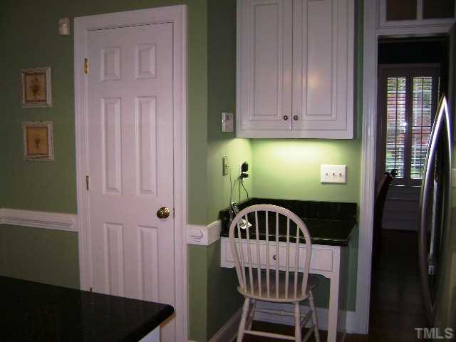 8101 Fallston Court Raleigh, NC 27613 - Photo 3 of 13 Kitchen features a built in desk and large panry Kitchen