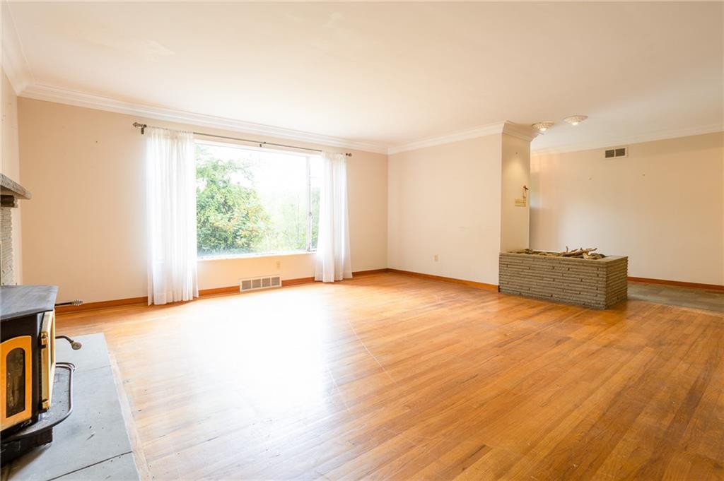497 Ross Road Eighty Four, PA 15330 - Photo 11 of 35 a view of an empty room with a window and wooden floor