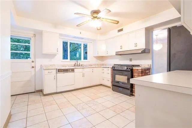 a kitchen with a stove a sink and a refrigerator
