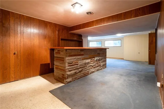 a view of an empty room with windows and cabinet