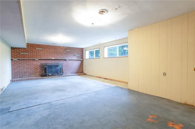 a view of empty room with a fireplace