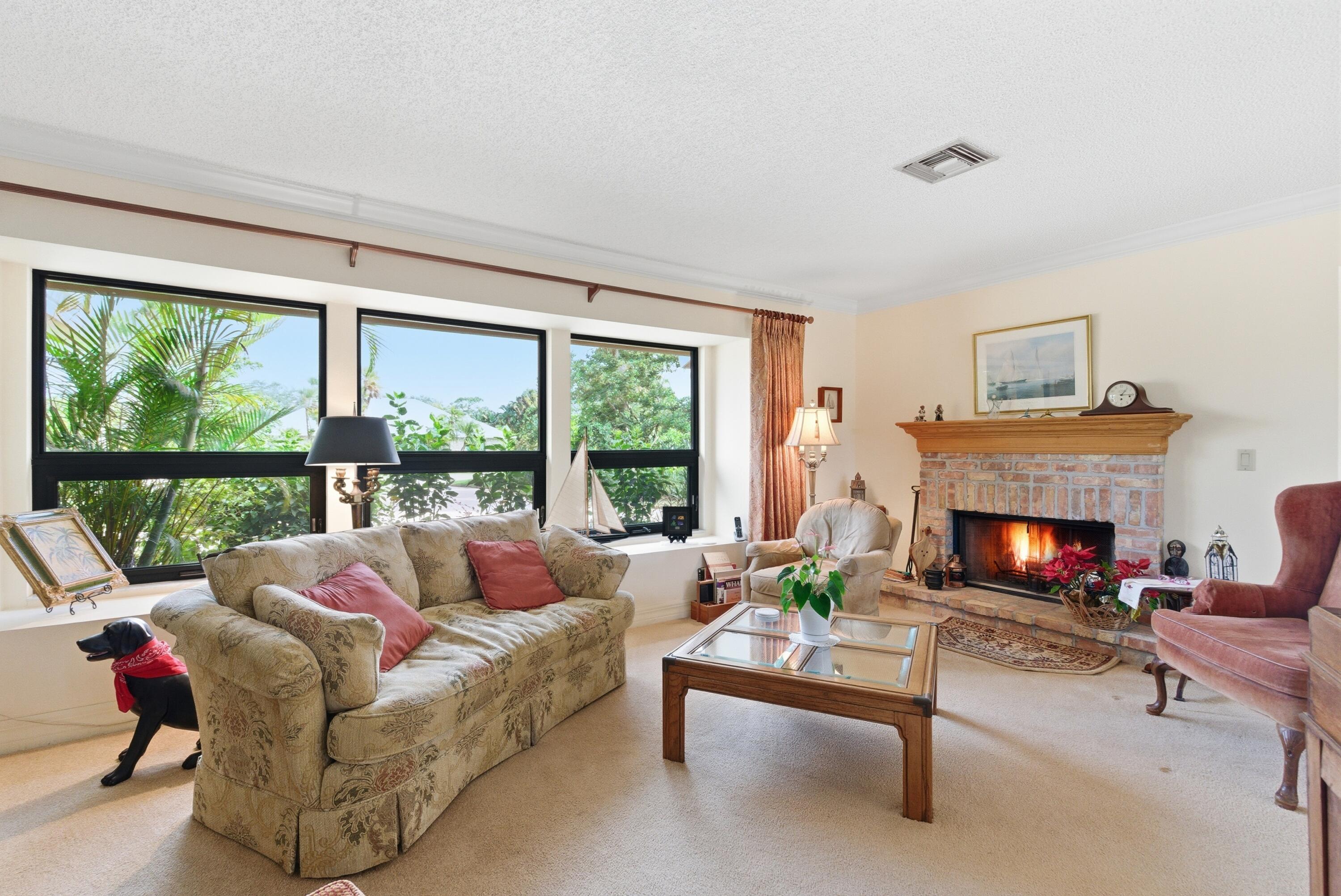 5081 Southeast Burning Tree Circle Stuart, FL 34997 - Photo 17 of 72 a living room with furniture and a fireplace