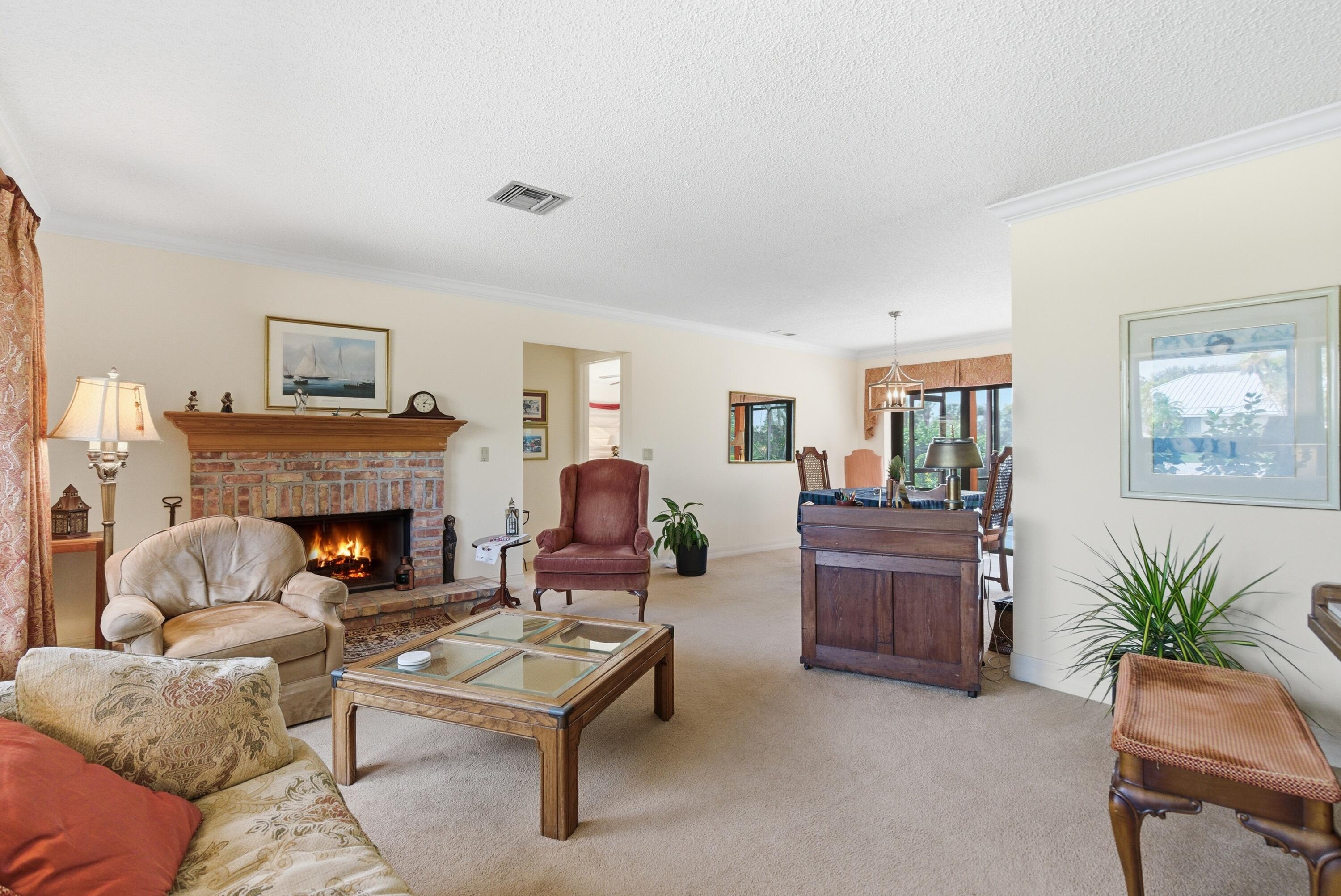 5081 Southeast Burning Tree Circle Stuart, FL 34997 - Photo 18 of 72 a living room with furniture and a fireplace