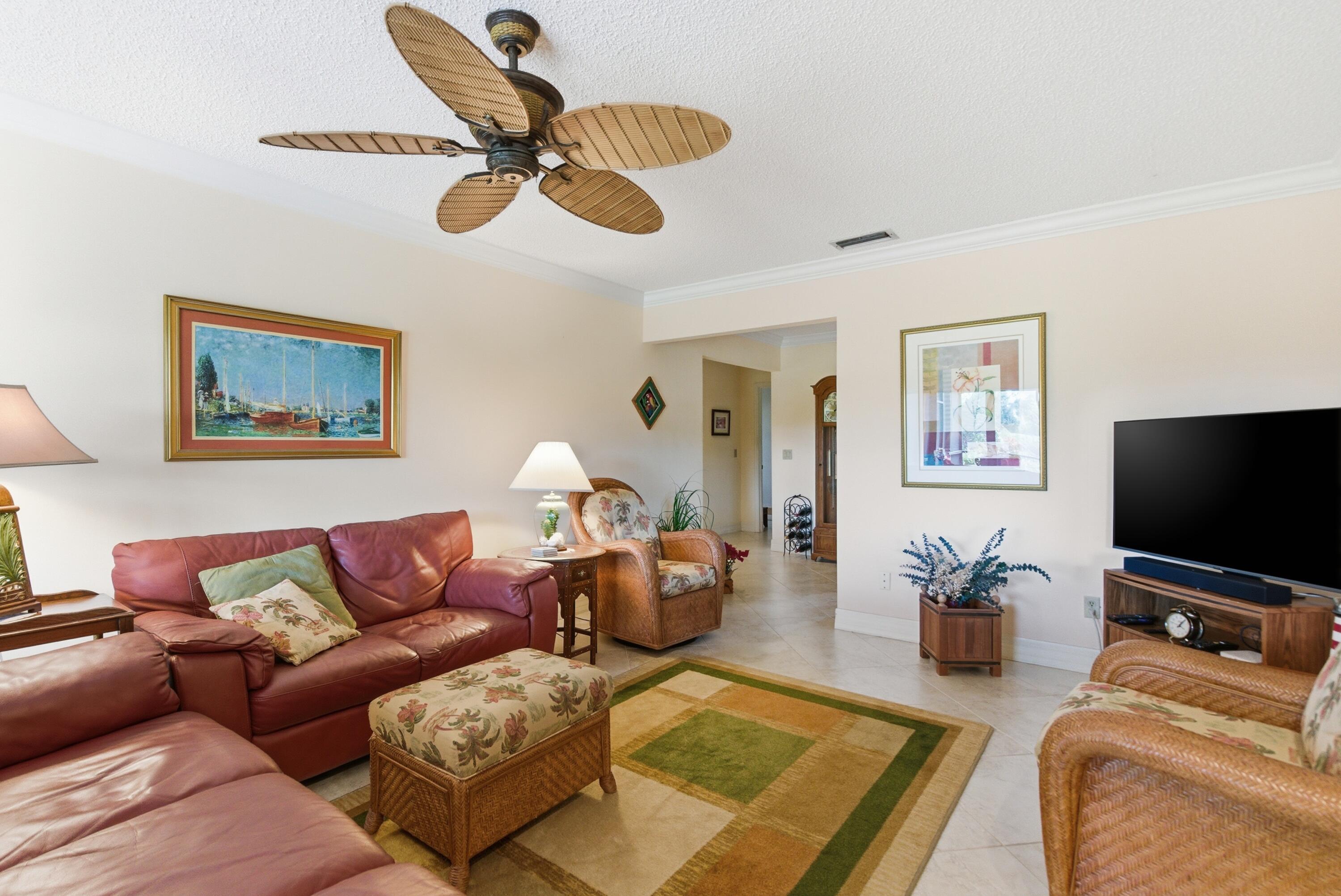 5081 Southeast Burning Tree Circle Stuart, FL 34997 - Photo 25 of 72 a living room with furniture and a flat screen tv