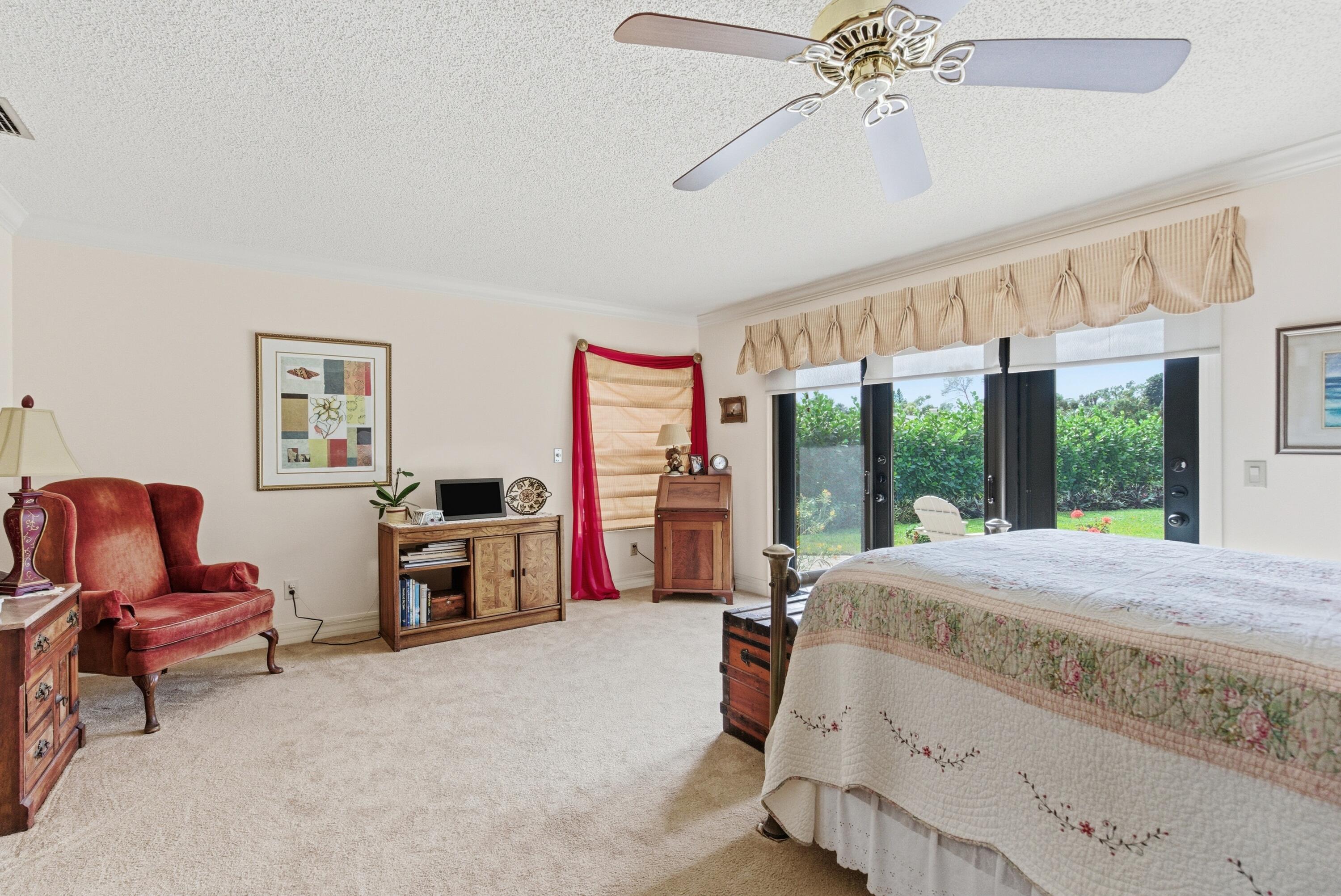 5081 Southeast Burning Tree Circle Stuart, FL 34997 - Photo 28 of 72 a bed room with a bed and a chair