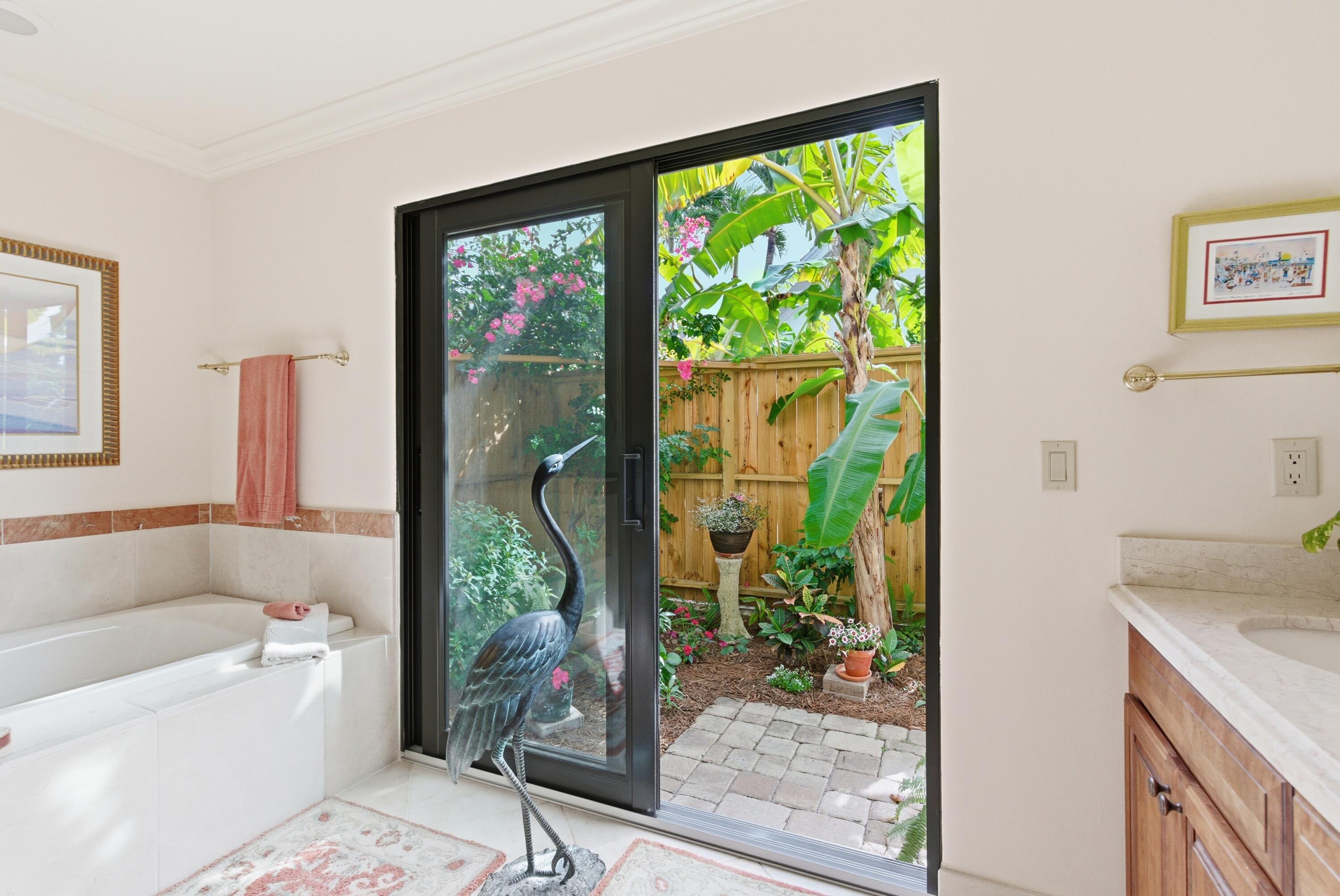 5081 Southeast Burning Tree Circle Stuart, FL 34997 - Photo 33 of 72 a bathroom with a granite countertop sink a mirror and next to a window