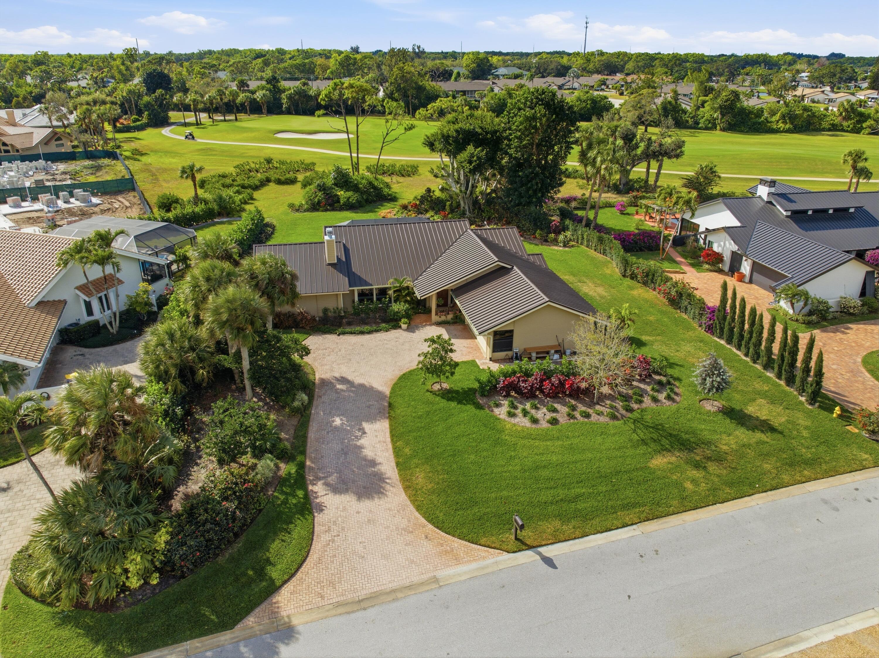 5081 Southeast Burning Tree Circle Stuart, FL 34997 - Photo 5 of 72 an aerial view of a house with outdoor space and a lake view